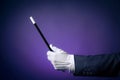 High contrast image of magician hand with magic wand Royalty Free Stock Photo