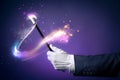 High contrast image of magician hand with magic wand