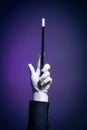 High contrast image of magician hand with magic wand Royalty Free Stock Photo