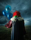 Scary clown on a field at night Royalty Free Stock Photo