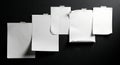 Five empty notes taped on a dramatic black surface Royalty Free Stock Photo