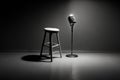 high contrast image of a stand up comedy stage with a microphone and a stool Royalty Free Stock Photo