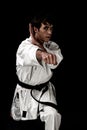 High Contrast karate young male fighter on black