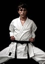 High Contrast karate young male fighter on black