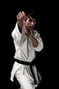 High Contrast karate young male fighter on black