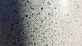 High Contrast Macro of a Speckled Monochromatic Surface with a Diagonal Shadow Royalty Free Stock Photo