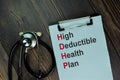 High Deductible Health Plan write on a paperwork isolated on wooden table