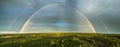 High detailed drone panorama of double rainbow over summer pine tree forest, very clear skies and clean rainbow colors. This photo