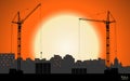 High detailed vector hoisting cranes building the town on sunset background