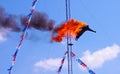 High diver performing a fire dive off a platform above a pool at a circus fair show