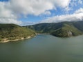 High drone aerial across the water to the Eungella Dam Wall