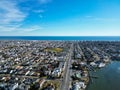 High drone aerial view of densely populated New Jersey shore towns by the ocean