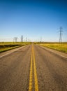 Electricity Pillars along an empty road in Alberta, Canada