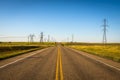 Electricity Pillars along an empty road in Alberta, Canada Royalty Free Stock Photo