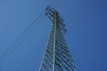 High electricity pylon during the sunny day with bright sun and blue sky Royalty Free Stock Photo