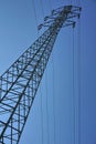 High electricity pylon during the sunny day with bright sun and blue sky Royalty Free Stock Photo