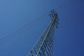 High electricity pylon during the sunny day with bright sun and blue sky Royalty Free Stock Photo