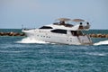 High-end cabin cruiser exiting Government Cut in Miami,Florida,heading for the open ocean,