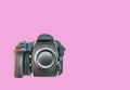 High end dslr camera front view, isolated on a pink background Royalty Free Stock Photo