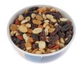 High energy trail mix with roasted nuts and fruit in a colorful bowl isolated on a white background Royalty Free Stock Photo