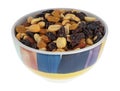 Side view of high energy trail mix with roasted nuts and fruit in a colorful bowl isolated on a white background Royalty Free Stock Photo