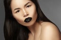 High Fashion Beauty Asian Model with bright Lip Gloss Make-up. Black Lips with gloss lipstick makeup. Long dark hair Royalty Free Stock Photo