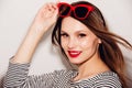 High fashion look.glamor stylish beautiful young happy smiling woman model with red lips and red sunglasses Royalty Free Stock Photo