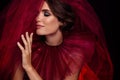 High fashion magazine photo shooting young dark bride lady wear ruby red dress lace veil eyes closed posing tenderness