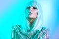 High fashion model girl in colorful bright neon lights posing in studio. Portrait of beautiful woman in white wig