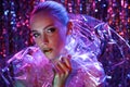 High Fashion model girl in colorful bright neon lights posing in studio through transparent film. Portrait of beautiful Royalty Free Stock Photo