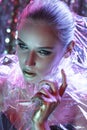 High Fashion model girl in colorful bright neon lights posing in studio through transparent film. Portrait of beautiful Royalty Free Stock Photo