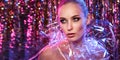 High Fashion model girl in colorful bright neon lights posing in studio through transparent film. Portrait of beautiful Royalty Free Stock Photo