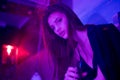 High Fashion model girl in colorful bright sparkles and neon lights posing in studio, portrait of beautiful woman, trendy glowing Royalty Free Stock Photo