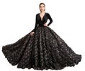 High Fashion Model in Long Black Wedding Dress. Woman in Evening Luxury Gown with Black Roses Lace. Elegant Lady Full Length