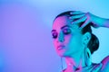 High Fashion model in metallic blue and pink lights Royalty Free Stock Photo