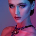 High Fashion model woman in colorful bright lights posing in studio. Royalty Free Stock Photo