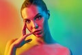 High Fashion model woman in colorful bright lights posing in studio Royalty Free Stock Photo