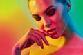 High Fashion model woman in colorful bright lights posing in studio Royalty Free Stock Photo