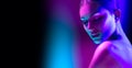 High Fashion model woman in colorful bright neon lights posing in studio, night club. Portrait of beautiful girl in UV