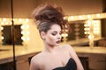 High Fashion Model woman with Mohawk hairstyle. Beauty makeup. Glamour updo hair style. Brunette Slim Lady in dressing Royalty Free Stock Photo