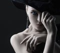 High fashion portrait of elegant woman in black and white hat and dress. Royalty Free Stock Photo