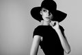 High fashion portrait of elegant woman in black and white hat an Royalty Free Stock Photo