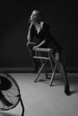 High Fashion Sexy Woman. Erotic Portrait Of Beautiful Model On Chair. Royalty Free Stock Photo