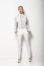 High Fashion. Trendy Woman in White Breeches in Graceful Pose. Spring Time Collection