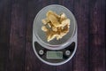 High fat low carb healthy snack - pork rinds measured on kitchen scale Royalty Free Stock Photo