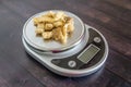 High fat low carb healthy snack - pork rinds measured on kitchen scale Royalty Free Stock Photo