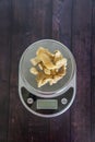 High fat low carb healthy snack - pork rinds measured on kitchen scale Royalty Free Stock Photo