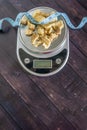 High fat low carb healthy snack - pork rinds measured on scale, measuring tape Royalty Free Stock Photo