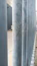 High fence made of thick metal pipes near the glass factory Royalty Free Stock Photo