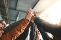 High five for acing that exam. a group of young students joining their hands together in solidarity on campus.